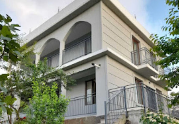 For sale a luxurious three-storey villa with a terrace and a huge garden.